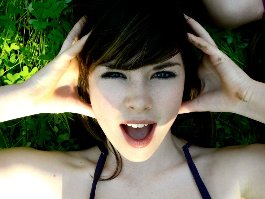 Beautiful girl with hands on head.
