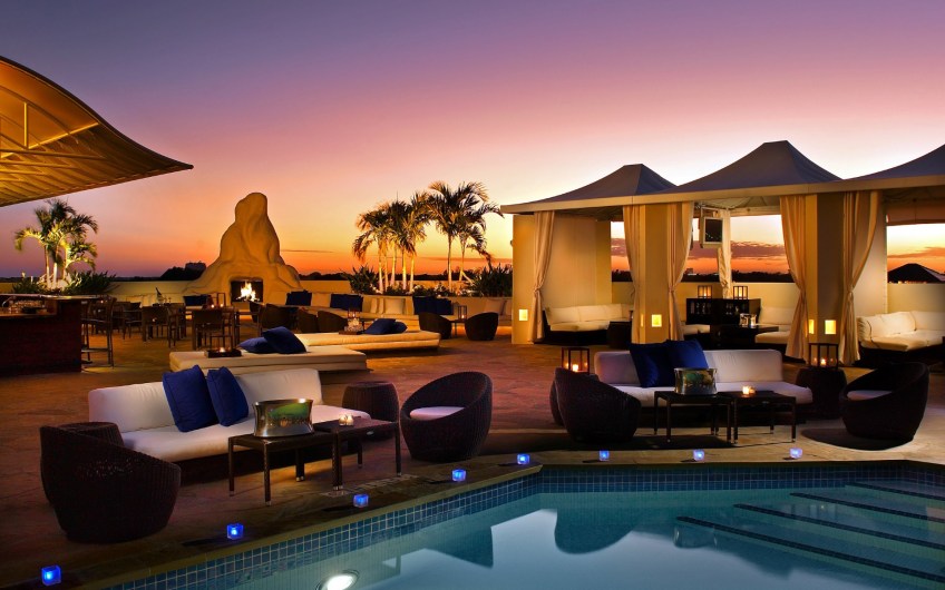 Elegant desert lounge, with pool and fireplace. Wallpaper.